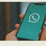 Person using smartphone with WhatsApp